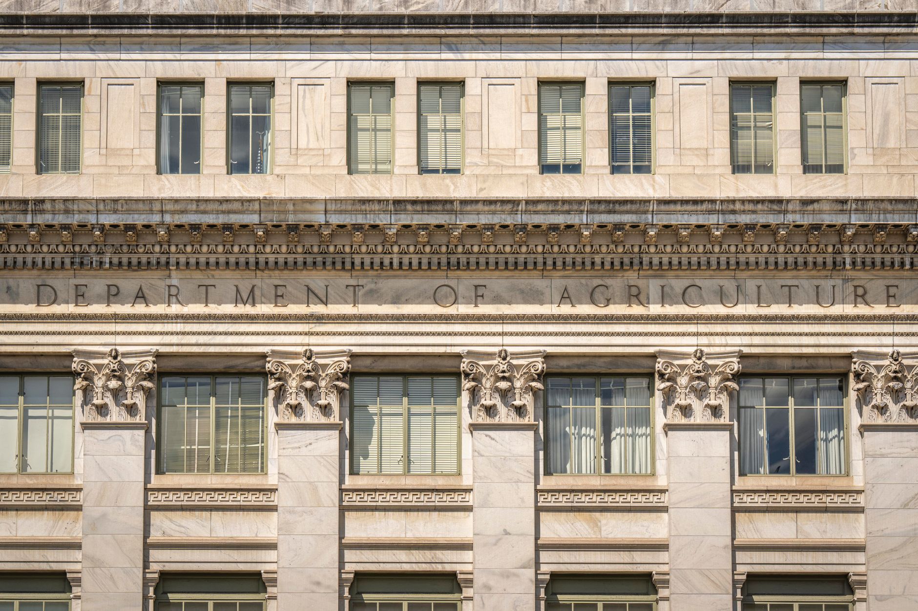 Close-up of the Department of Agriculture building's architectural facade, showcasing intricate columns and windows.