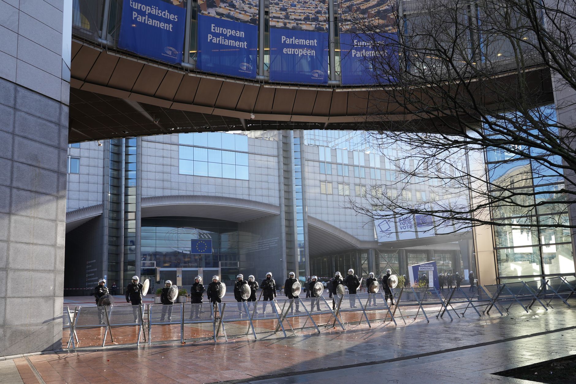 Police officers stand guard outside the European Parliament building in Brussels, Belgium.