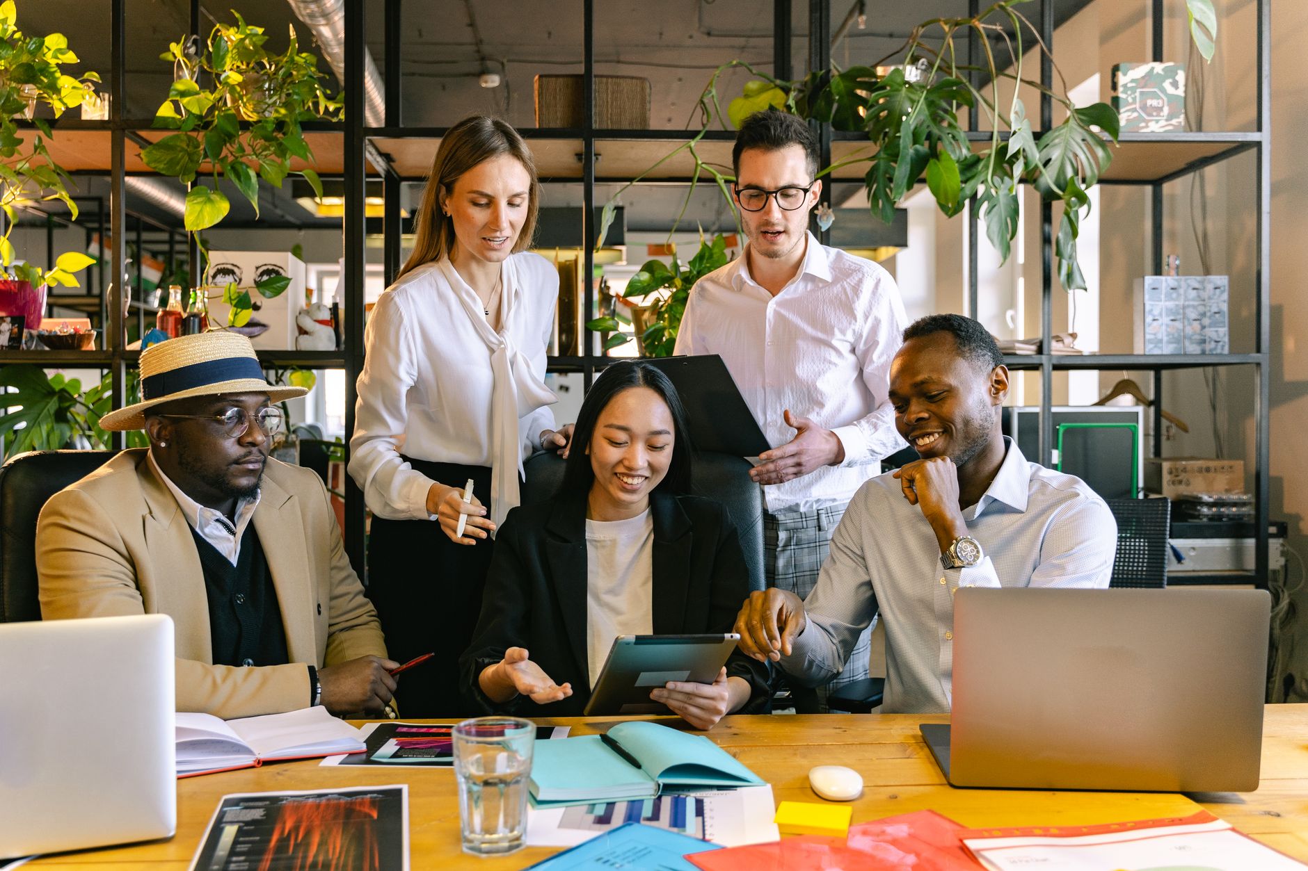 A group of diverse professionals working collaboratively in a modern office setting.