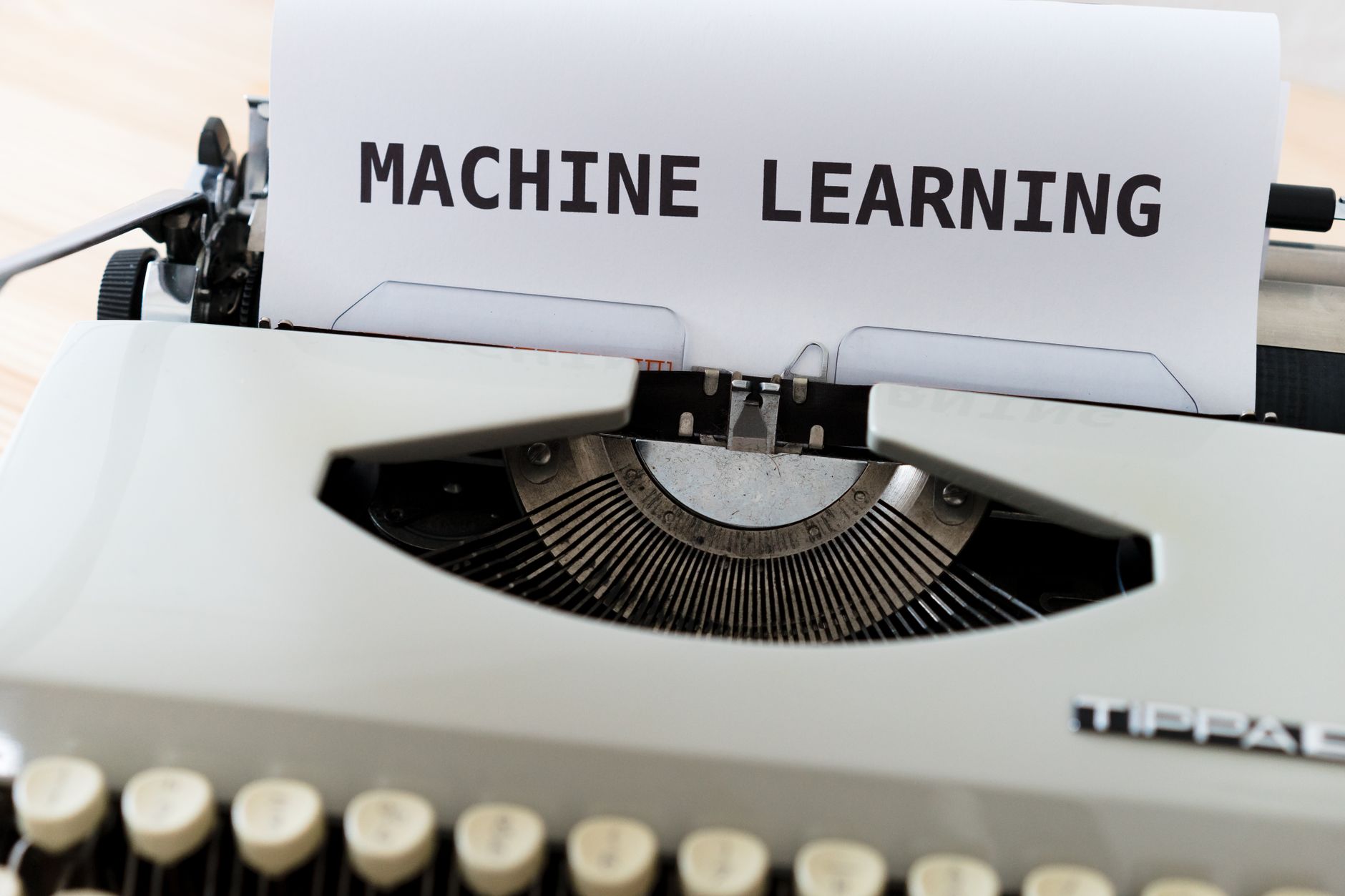 Vintage typewriter displaying 'Machine Learning' text, blending old and new concepts.