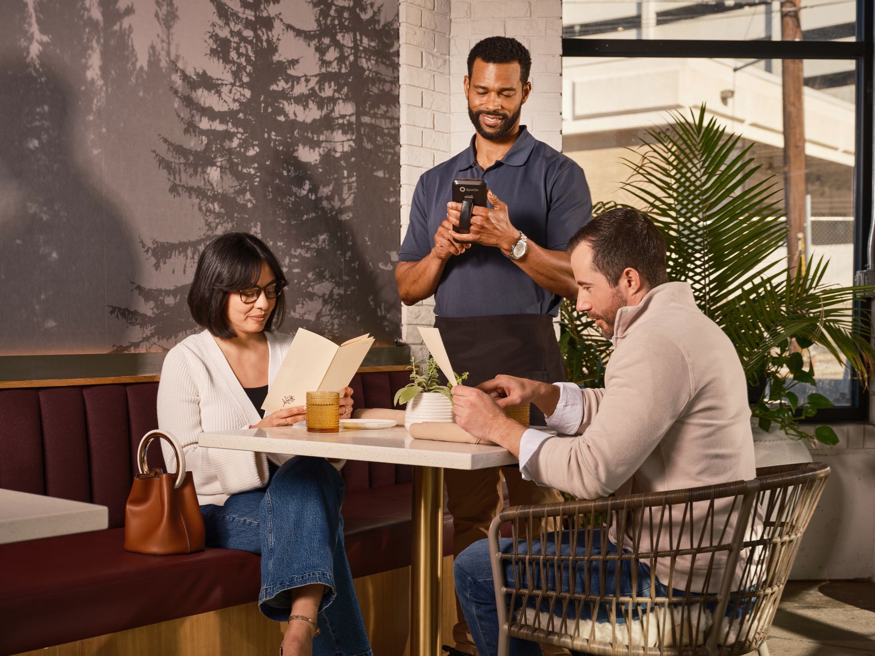 Customers in a café enjoy efficient service with mobile ordering on a modern POS system.