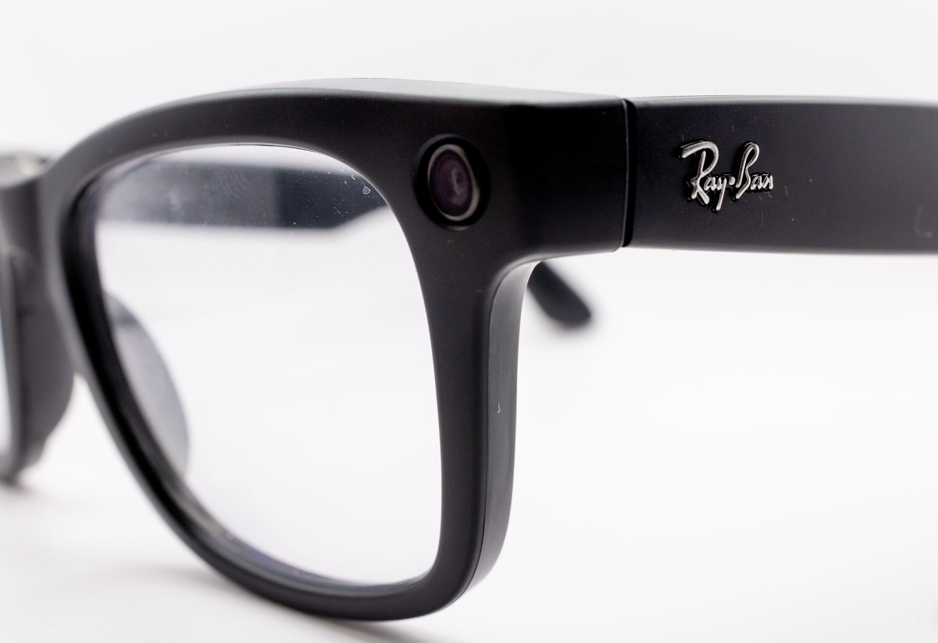 Detailed close-up shot of black smart glasses featuring a built-in camera, highlighting modern technology and design.